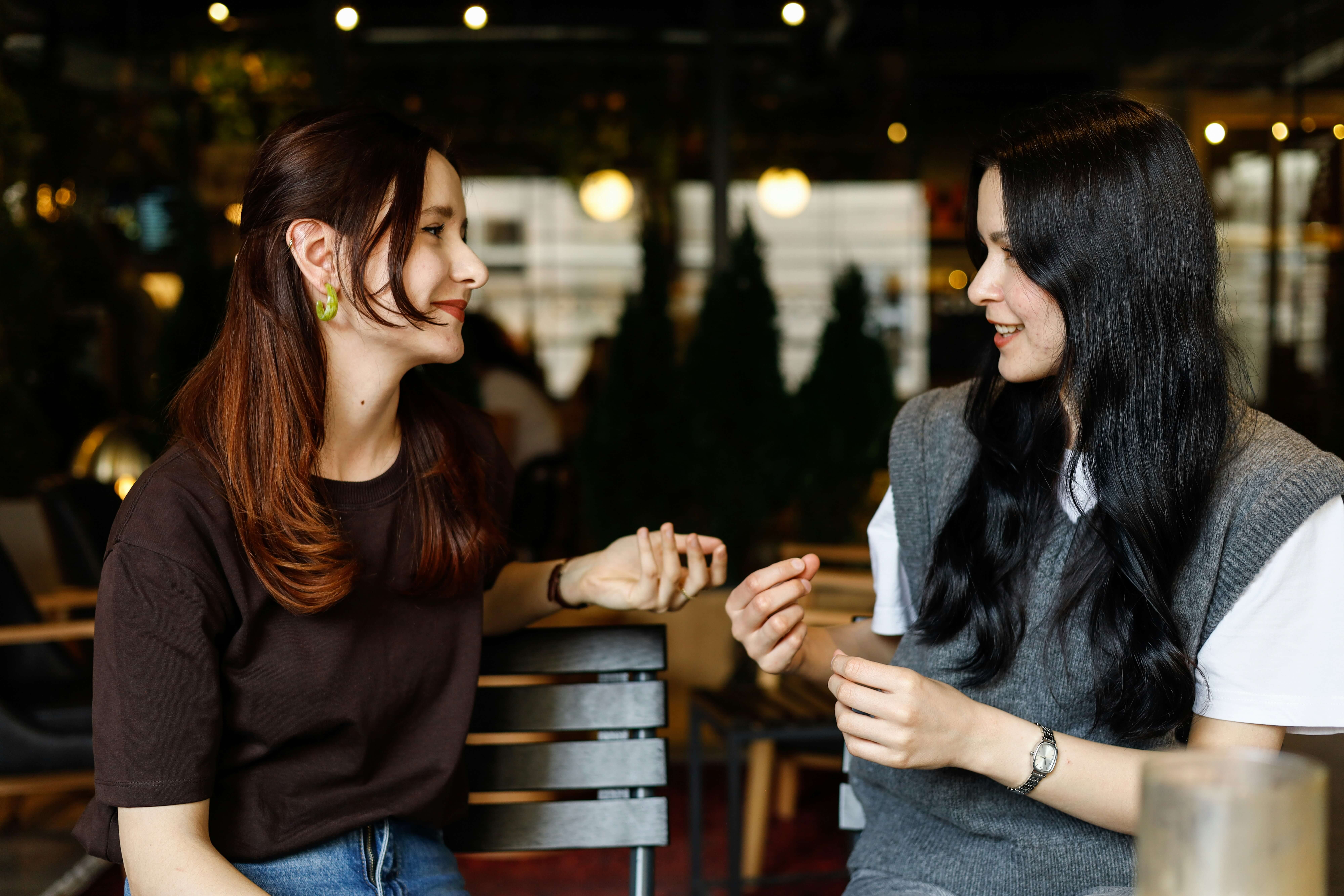 A potential new member talking and laughing with a sorority member during a recruitment round