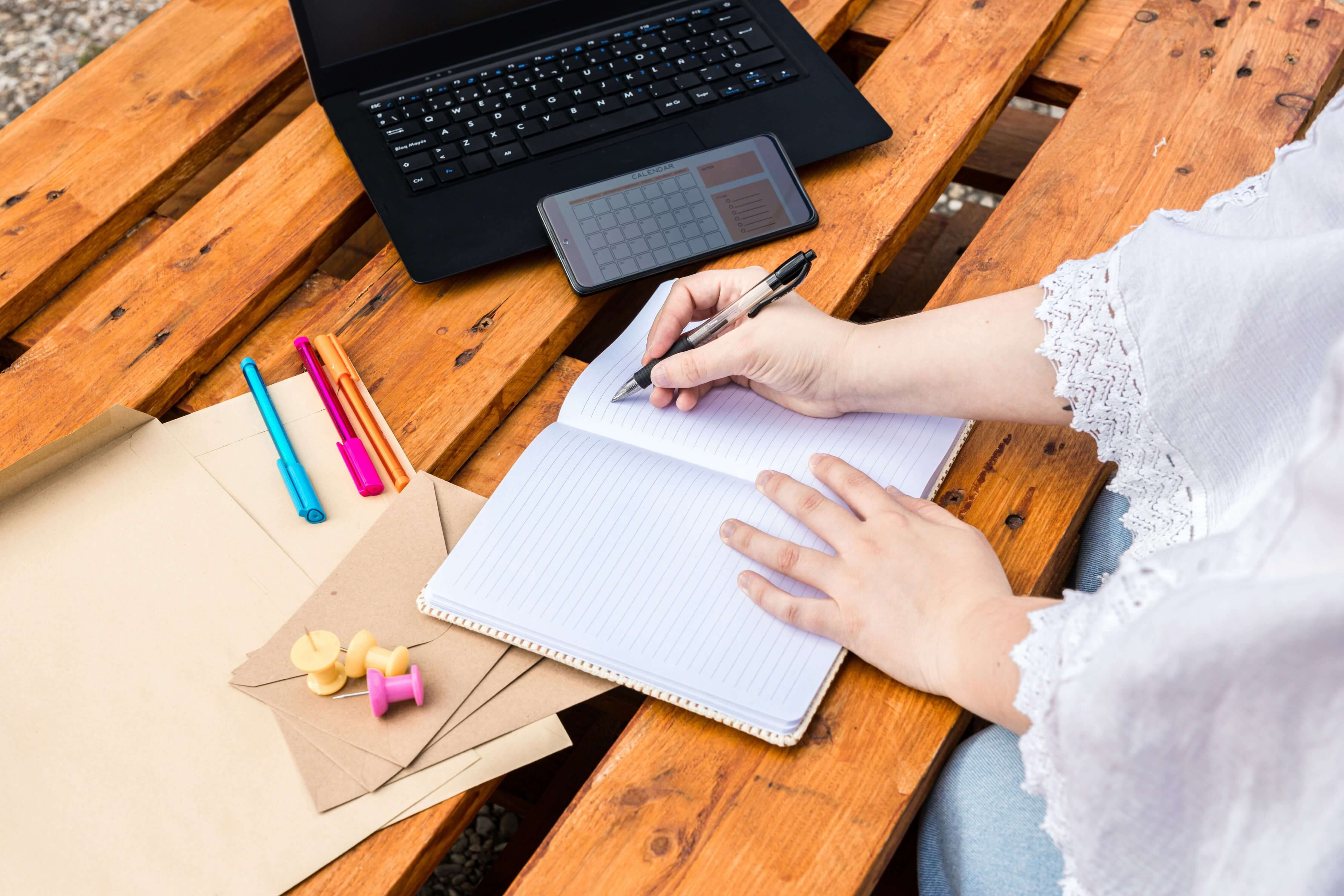 A handwritten letter, a laptop open to a sorority's introduce-yourself form, and a resume laid out on a desk.